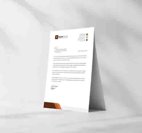 Free letterhead paper mockup standing on soft fabric background
