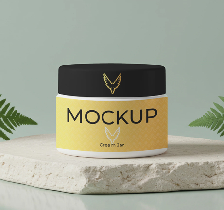 Free cream jar mockup on stone base with green ferns